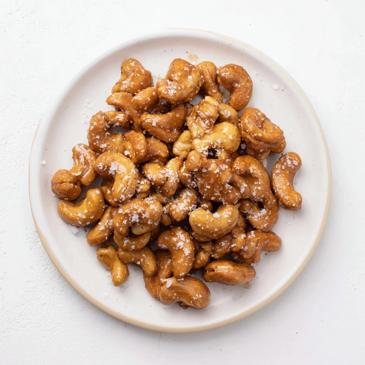Close-up of freshly baked sweet and salty honey toasted cashews, glistening with honey and salt.