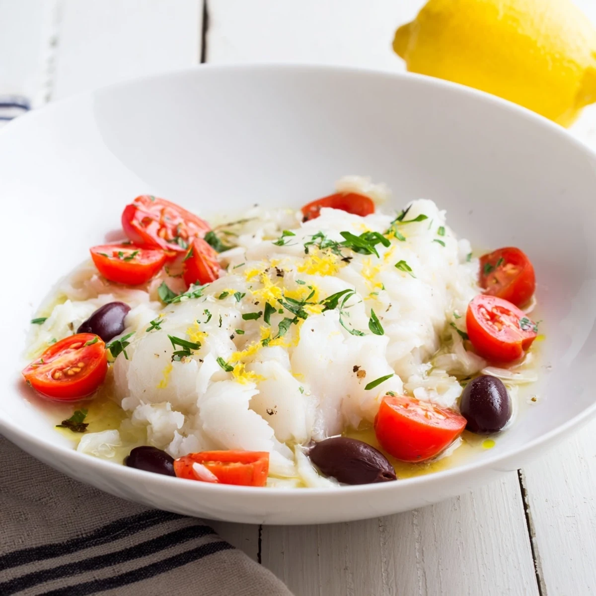 Golden baked One-Tray Cod with cherry tomatoes, olives, and herbs, ready to serve, looks delicious.
