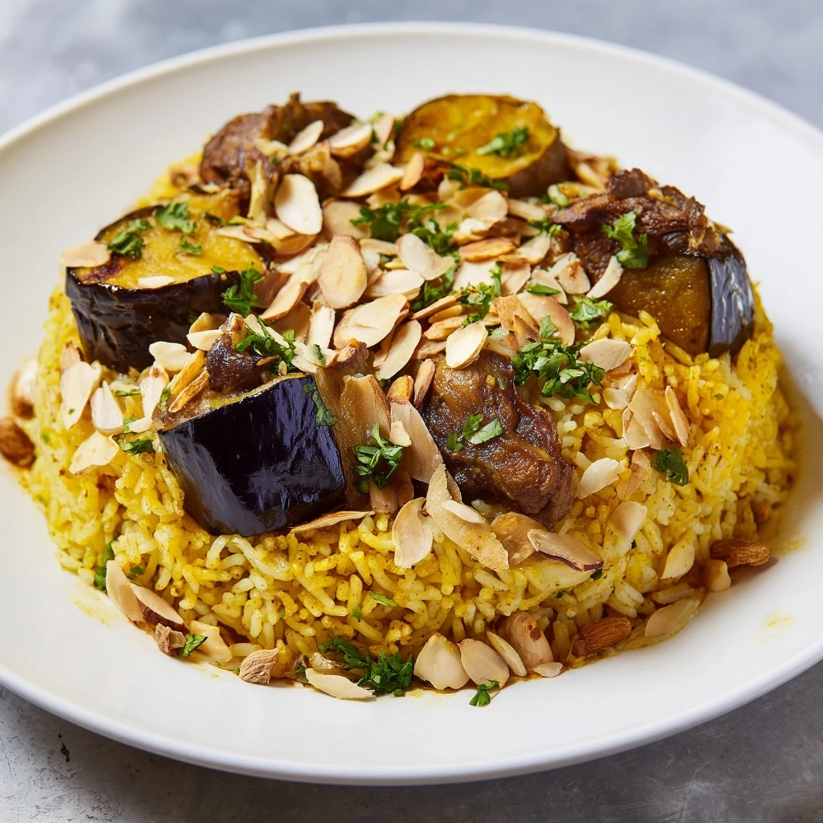 A beautifully flipped Maqluba main dish, showing layers of rice, vegetables, and tender meat.