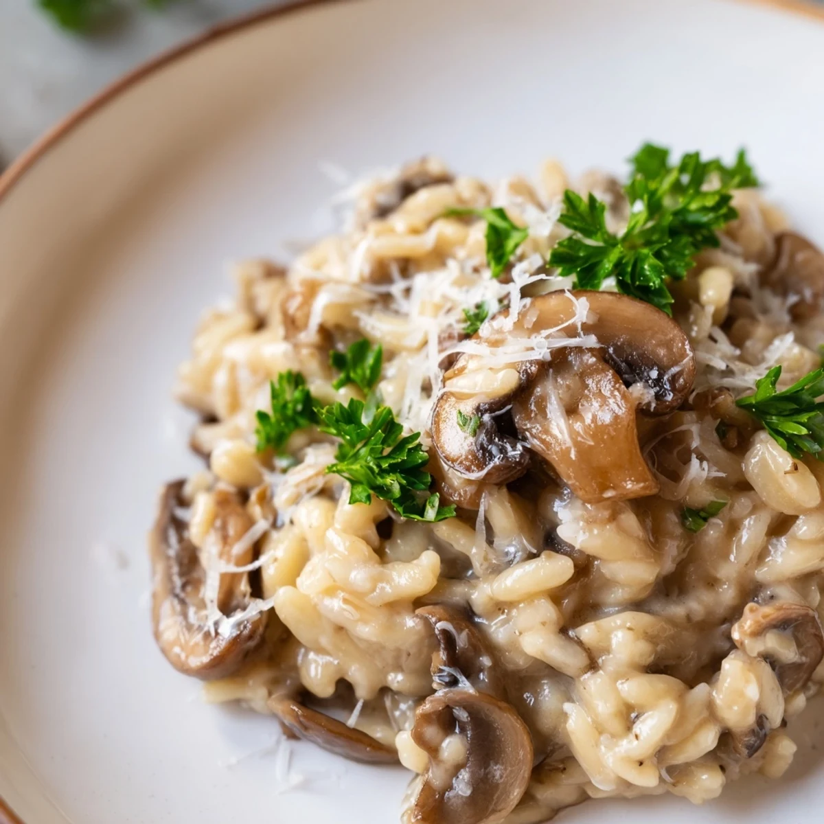 Creamy Orzo Mushroom Risotto-Style in a white bowl, garnished with fresh parsley and extra Parmesan, steam rising from the silky surface.