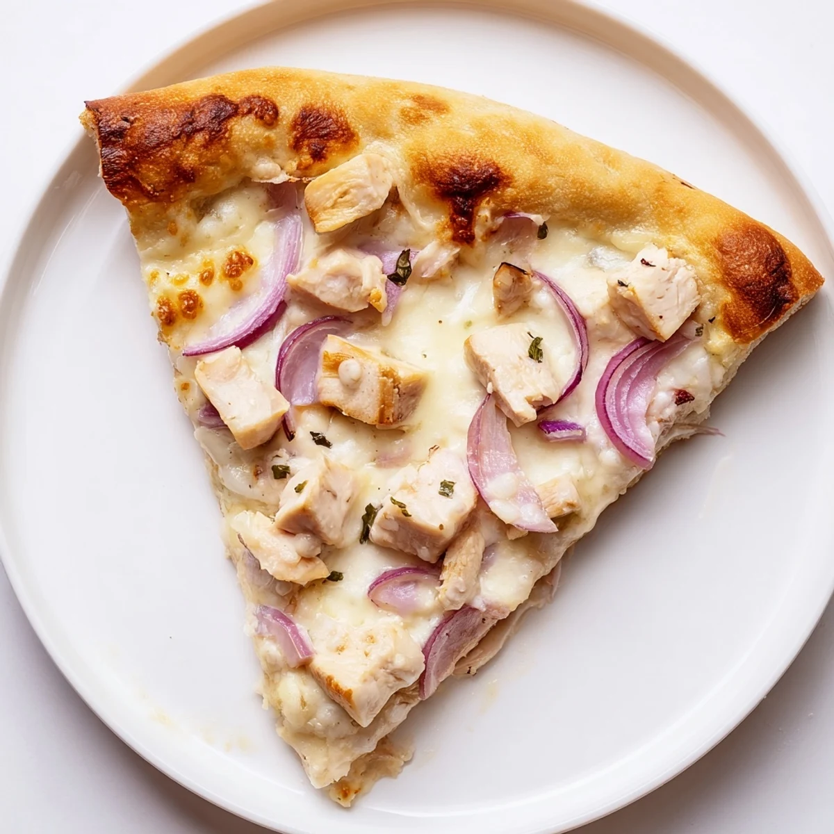 Sliced Chicken Alfredo Pizza reveals layers of savory chicken and gooey cheese, perfect for a weeknight Italian-American dinner.