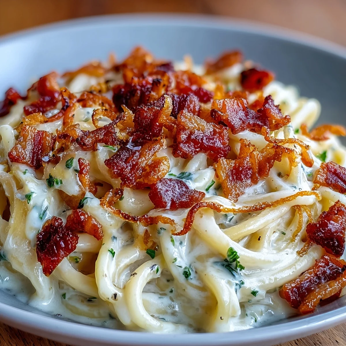 Golden celeriac carbonara twirled on a fork with crispy pancetta and melted Parmesan.
