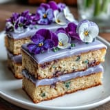 Mini Spring Birthday Layer Cakes with Edible Flowers: Delicate vanilla-lemon mini cakes layered with silky buttercream and adorned with fresh edible flowers for a festive, springtime birthday treat.