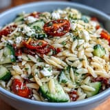 Creamy feta and crisp cucumber tossed with tender orzo in a bright, herb-infused lemon dressing for a refreshing side dish.  
