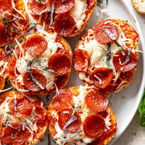 Mini pepperoni pizza bagels just out of the oven, with melting cheese and crispy pepperoni.