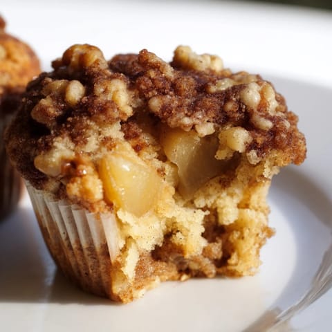 Golden Seasonal Spiced Pear and Walnut Muffins, freshly baked, offering a warm spiced aroma, ready to be enjoyed.