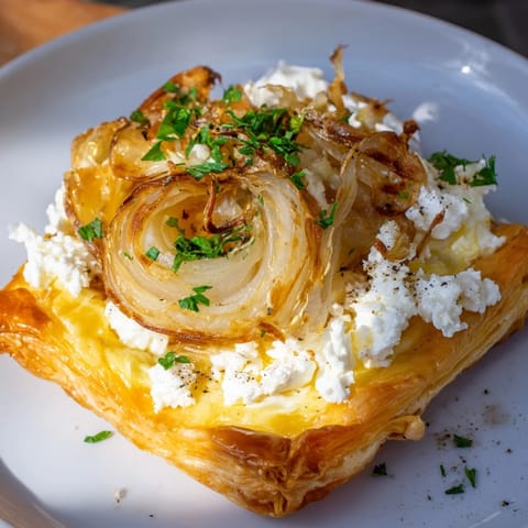 Golden, caramelized onions topping a flaky crust of this decadent goat cheese tart.