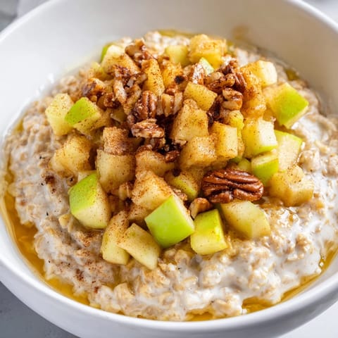 A close-up view of a beautifully prepared apple pie oatmeal bowl, perfect for a cozy morning meal.
