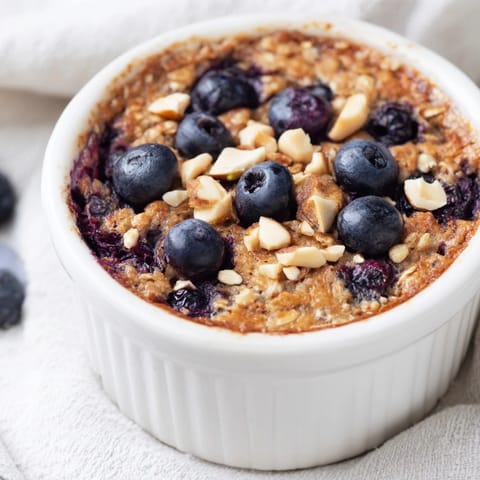 Warm and comforting Blueberry Baked Oats, offering a sweet, cake-like texture, perfect for breakfast.