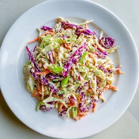 Creamy coleslaw salad, with sunflower seeds, offers a bright combination of textures and flavors.