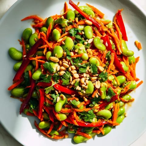 A refreshing bowl of Asian Edamame Salad, featuring colorful vegetables and crunchy sesame seeds, perfect for lunch.