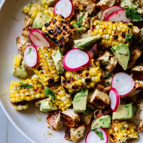 This hearty Roasted Corn & Chicken Chopped Salad features charred kernels, tender chicken, and colorful veggies drizzled with a bright, tangy vinaigrette.  