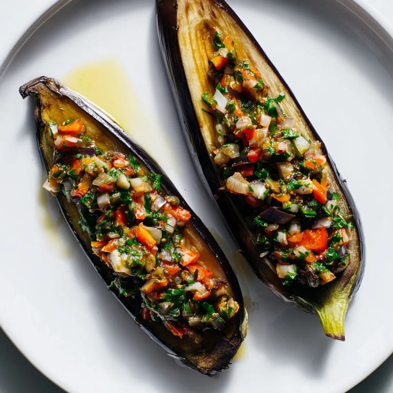 Steaming hot Imam Bayildi with tender eggplant halves, perfect for a flavorful vegetarian dinner on a plate.